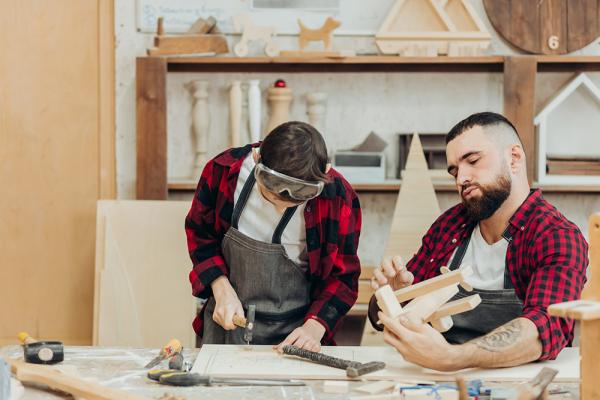 Two young men working in a woodshop
